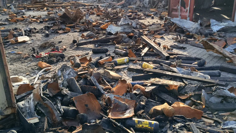 Nach den Explosionen in einer Lagerhalle an der Müggenburger Straße liegen verkohlte Trümmer und verbogenes Metall verstreut.