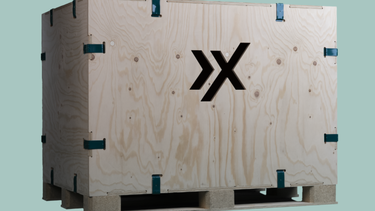 AXXUM kliXXkiste: Holzversandkiste mit blauen Metallklammern und einem schwarzen Logo an der Seite,