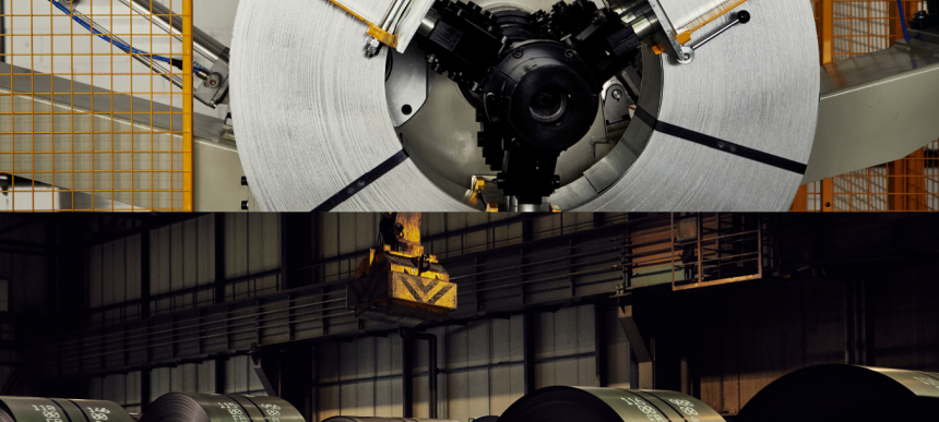 Nahaufnahme einer großen Metallspule in einer Fabrikumgebung mit Maschinen und orangefarbener Gitterbarriere. Darunter mehrere gestapelte Metallspulen in einem schwach beleuchteten Industrielager.